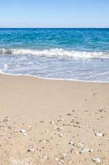 Fototapeta na wymiar Seascape background colorful sea waves on sandy beach