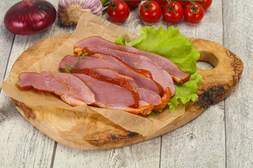 Sliced smoked duck breast served salad
