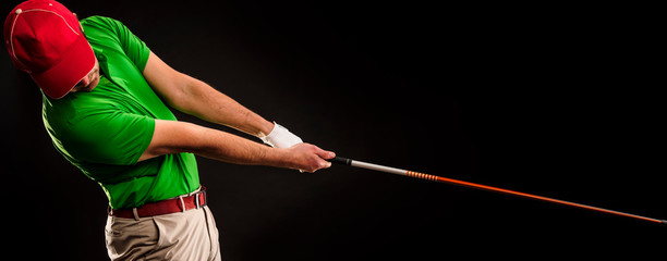Portrait of a golf player hitting the perfect golf shot isolated on dark background, banner image