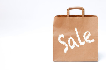 paper bag on a white background, concept of seasonal discounts, black friday, time for shopping, free space on the left