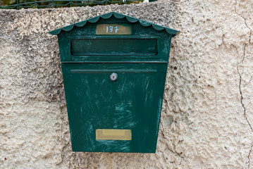 Scratched green letter box