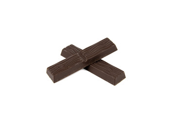 Black chocolate pieces isolated on white background. Sweet chocolate pieces