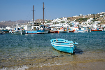 Scenic view of the old town on the Greek island of Mykonos. Fishing boats on the background of the sea and white houses