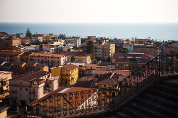 Amantea, Calabria Italy. Panorama of old city, aerial view with coast and sea. Sea with sunset at background.