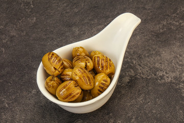 Green grilled olives in the bowl