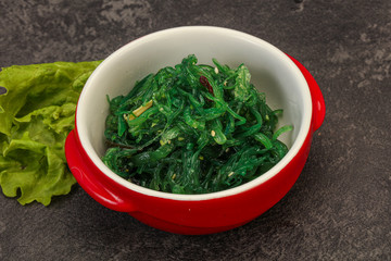Green Chuka Seaweed Salad Isolated on White Background Top View. Wakame Sea Kelp Salat
