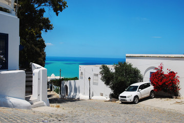 View of the blue sea and the street with white houses in Sidi Bou Said in Tunisia in summer in...