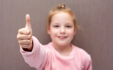 Child girl shows class thumb