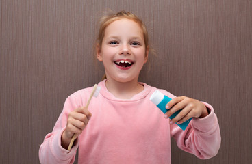Child girl with toothbrush and paste