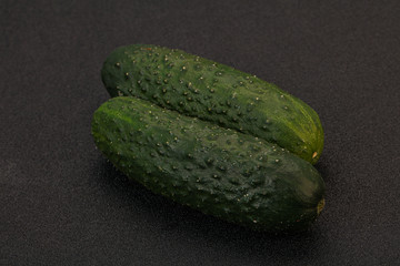 Green fresh cucumbers over background