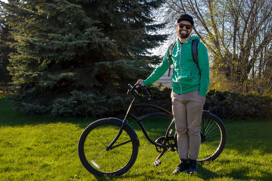 caucasian smiling bearded guy cyclist velo biker canadian gatineau quebec spring with a black bike