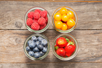 berries as square arrangement, raspberries, strawberries, blueberries and physalis