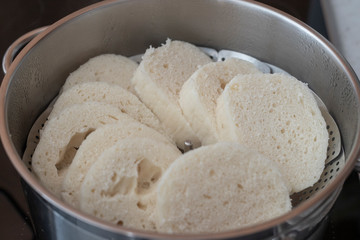 Fototapeta na wymiar Czech yeast dumpling sliced into wheels and put into