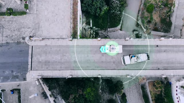 An autopilot street sweeper cleans the city streets. Aerial view, top to bottom. Future technology concept.