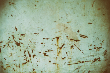 surface of the wall with blots scratches and cracks dark on a light background