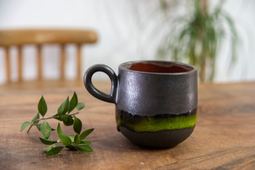 colorful handmade ceramic coffee cup on wooden table