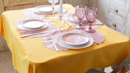 kitchen interior. festive table with yellow tablecloth