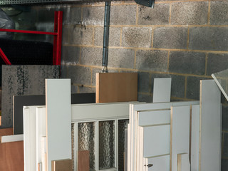 Construction site with concrete blocks and wooden doors and boards close-up.