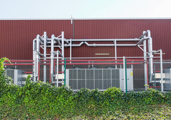 Facade of a plant with pipes in the foreground.
Side view and close-up