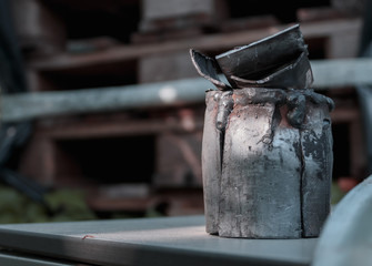 Old rusty metal pipe on a plastic surface in an industrial area. Very close up and side view.