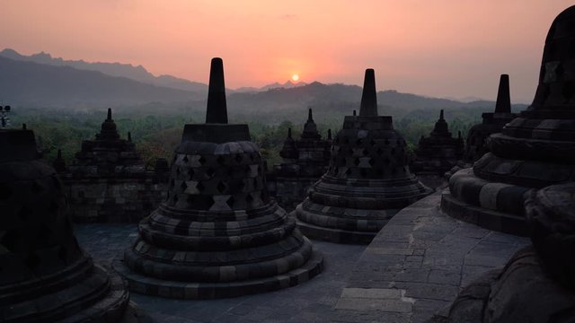 sunset over stupas of borobudur indonesia