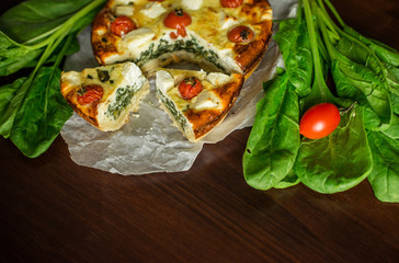 Pie with spinach and vegetables. Homemade pastries.