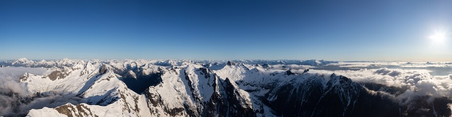 Obraz premium Aerial Panoramic View of Remote Canadian Mountain Landscape during sunny morning. Located near Vancouver, British Columbia, Canada. Nature Panorama Background. Authentic