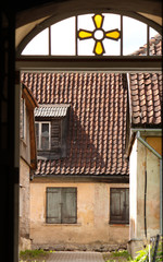 Fototapeta na wymiar View from an entrance of a house across the street onto another old ancient house in Baltics