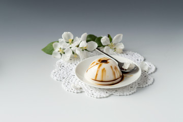 Fototapeta na wymiar Sweet dessert. Homemade vanilla pudding with chocolate on a small dessert plate. Selective focus.