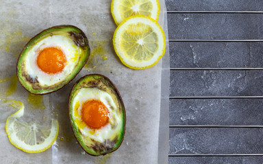 baked egg in avocado Boats. Top view, flat lay