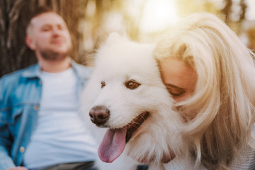 Happy couple spending time outdoors with their pet dog