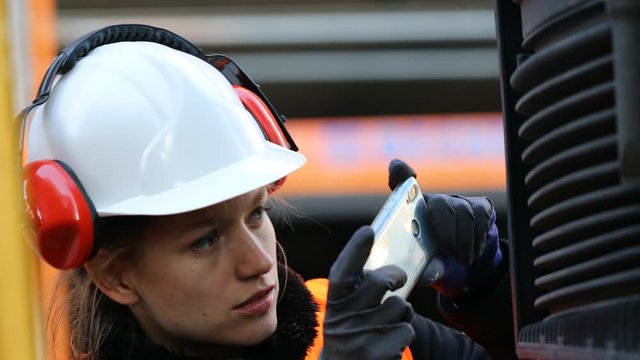 Female technician taking picture truck during control