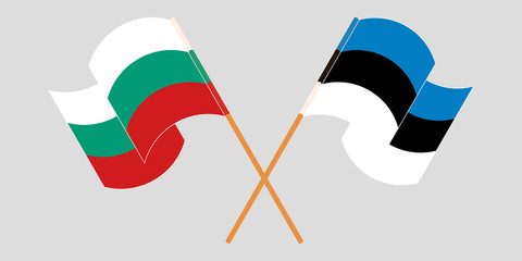 Crossed and waving flags of Bulgaria and Estonia