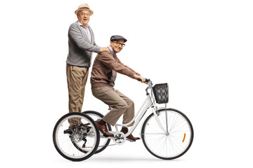 Elderly men riding on a tricycle