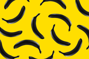 Black banana on a yellow background Pattern texture. Modern design Pop art