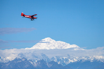 Bush Pilot flies plane over Alaskan mountains