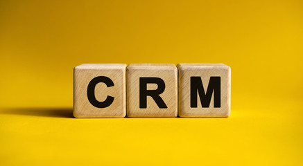 CRM text on a yellow background on wooden cubes