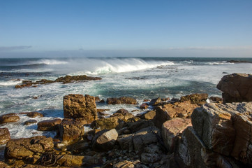 Fototapeta na wymiar waves crashing on rocks difficult revier