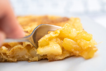 detail of fork picking up a piece of potato omelette