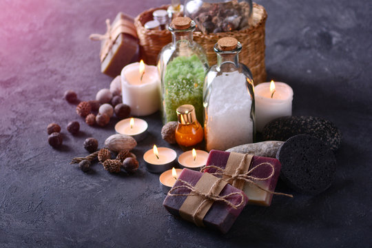Spa and bathroom background with handmade soap, sea salt, candles and other products for spa treatments