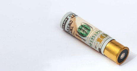 Cartridge of the 12th caliber, loaded with one hundred dollar bills. Isolated on white background