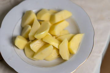 Sliced ​​raw potatoes lie in a plate