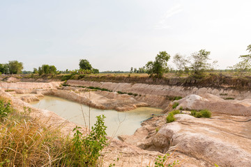 Dry land with broken soil represent hot weather and global warming. Aerial view showing low water level . Climate change and drought land. A dried up empty reservoir