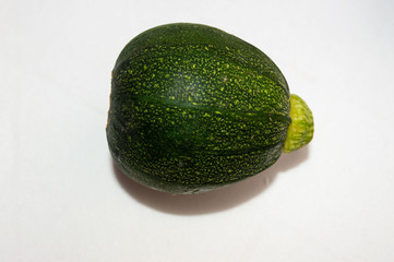 One isolated zucchini round green close-up on a white background.