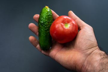 Tomato and cucumber in the palm of your hand