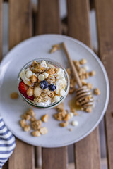 Healthy breakfast homemade granola with variety fruits and berries. Milk yogurt granola meal. Mental heath. Organic food. Vegetarian, vegan dietary. Organic meal. Food detox. Nutritional breakfast.
