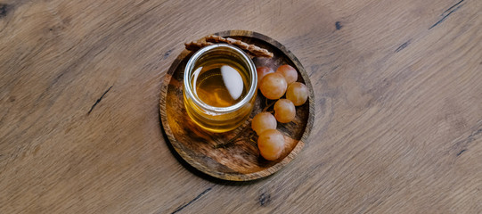 Healthy snack set with muscat grapes and honey on wooden background. 