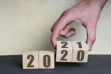 New year 2020 change to 2021 concept, hand change wooden cubes