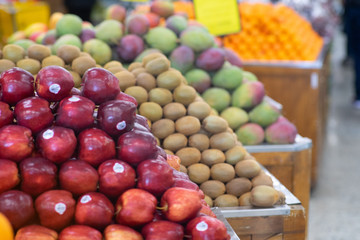 Perfectly ordered fruits on the market. Apples, mangoes, Lulos.