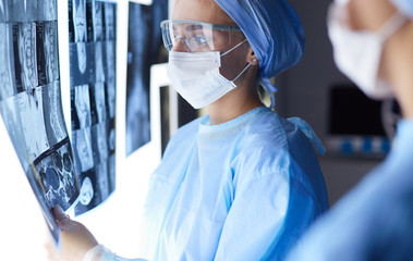 Two female women medical doctors looking at x-rays in a hospital